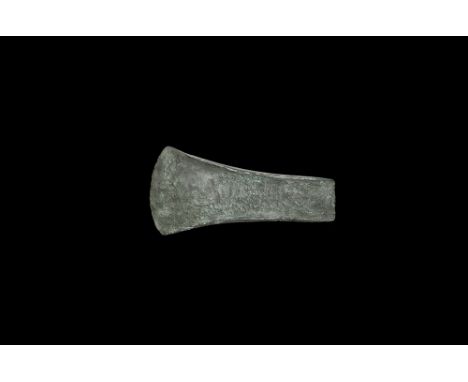 Early 3rd-late 2nd millennium BC. A bronze 'Migdale' type straight-sided flat axe with thin curved butt, facet to the blade w