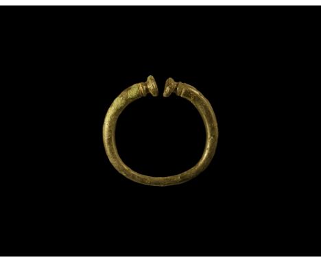 4th-1st century BC. A bronze miniature penannular torc, round in section with expanding buffer terminals. See Megaw, R.& V. E