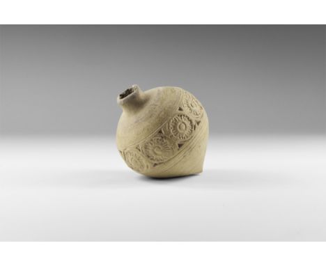 9th-11th century AD. A hollow ceramic vessel with a thick nozzle, piriform body with floral panels, conical base.  282 grams,