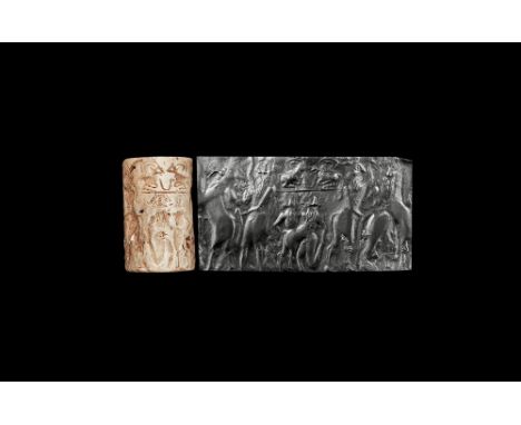 Old Akkadian, late 3rd millennium BC. A very large cylinder seal in fossil shell depicting contest scene with a lamassu and b
