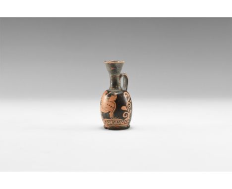 5th-3rd century BC. A ceramic blackware lekythos with rounded base, barrel-shaped body, trumpet mouth and strap handle to the