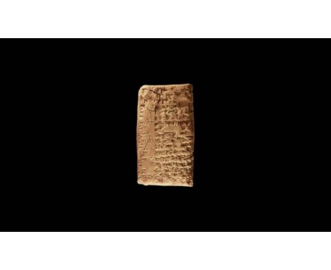 20th-19th century BC. A cuneiform clay tablet with text to both broad faces and one edge; accompanied by an old scholarly not