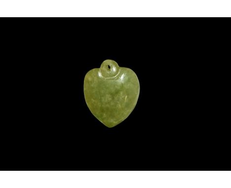 20th century AD. A heart-shaped jade pendant with pierced suspension lug.  4.99 grams, 26mm (1"). Property of a London gentle