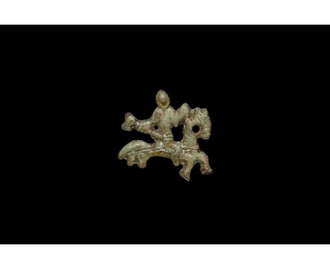 9th-12th century AD. A bronze mount of a horseman modelled in the half-round with axe in one hand the other on the reins.  6.