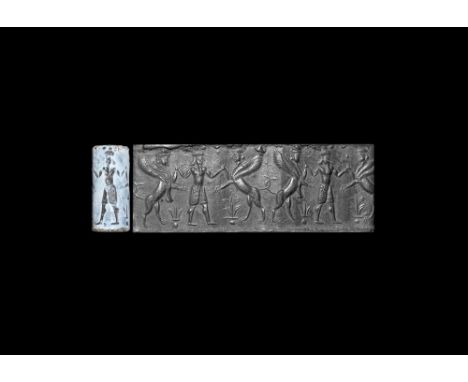 1st millennium BC. A chalcedony cylinder seal with intaglio design of a kilted hero with headgear and beard grasping the fore