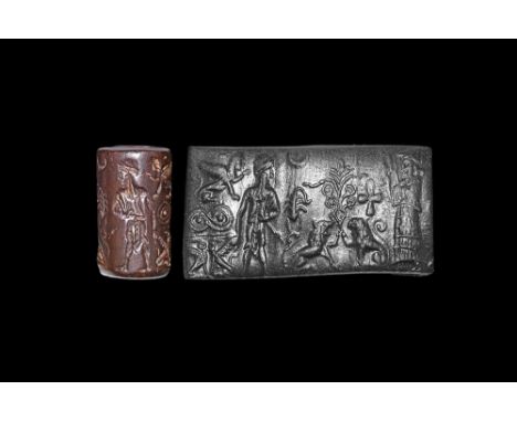 18th-17th century BC. A carved haematite cylinder seal with a central design of a tree guarded by a pair of lions, ankh and s