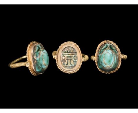 Early 1st millennium BC. A glazed composition scarab with hieroglyphic amuletic text to the underside; mounted in a sympathet