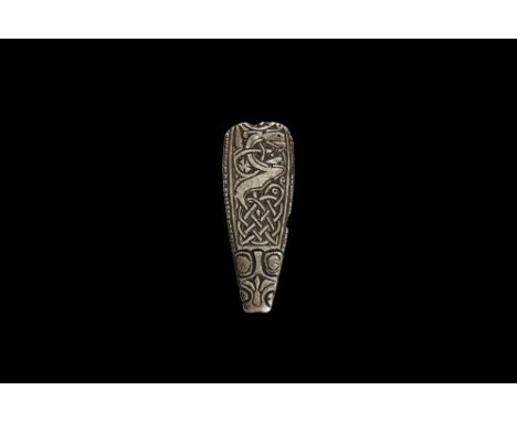 9th century AD. A silver tongue-shaped strap end with split upper end, beast-head finial with trefoil to the snout and D-shap