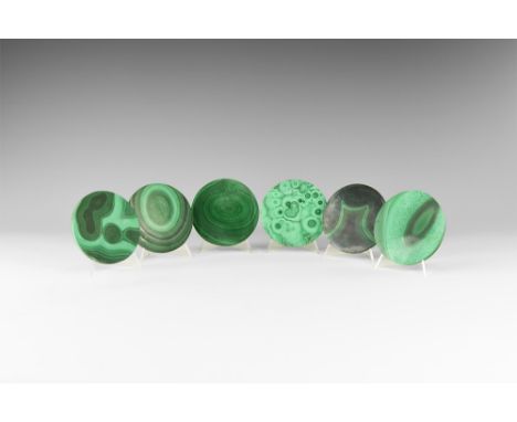 A group of six cut and polished circular malachite coasters with pale and dark green banding. See Bonewitz, Dr. Ronald Louis,