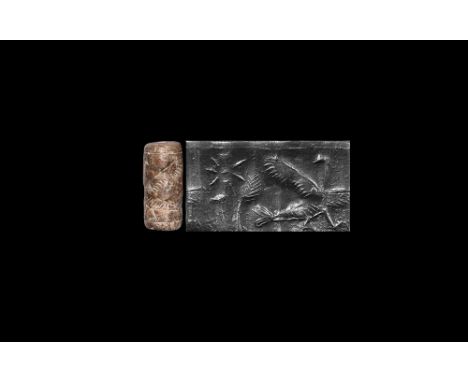 9th-8th century BC. A carved stone cylinder seal with standing bird facing a terminal with a star, accompanied by a typed and