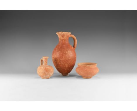 Early 2nd millennium BC. A mixed group of ceramic vessels comprising: a piriform jug ornamented with red burnished slip with 