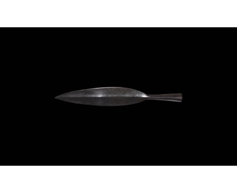 1st-3rd century AD. A substantial iron spearhead with broad leaf-shaped blade, short neck, flared closed socket with hole for