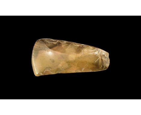 Neolithic, 4th-2nd millennium BC. A knapped and polished flint axehead with broad curved cutting edge and narrow butt. Cf. Ev