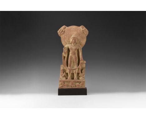 Gupta Period, 4th-6th century AD. A red sandstone figure of the Buddha with large halo decorated with scrolling plants, roset