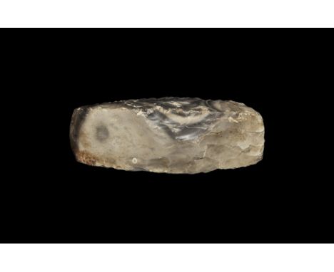 Neolithic, 6th-3rd millennium BC. A knapped axe of rectangular section with slightly tapering sides and square butt, polished