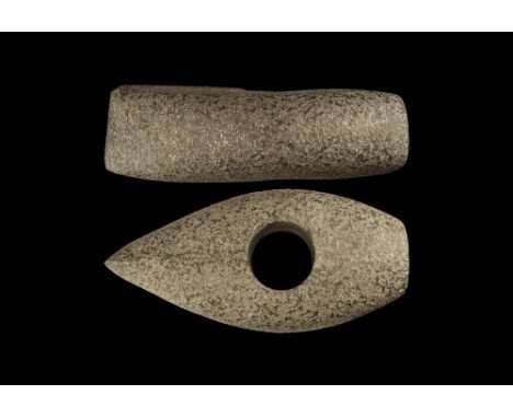 Neolithic, 4th-2nd millennium BC. A ground diorite axehead with median swelling, round mounting hole, raised median rib to th
