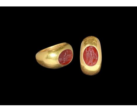 2nd century AD.A substantial D-section gold hoop with expanding shoulders, inset carnelian cloison with intaglio image of Dio