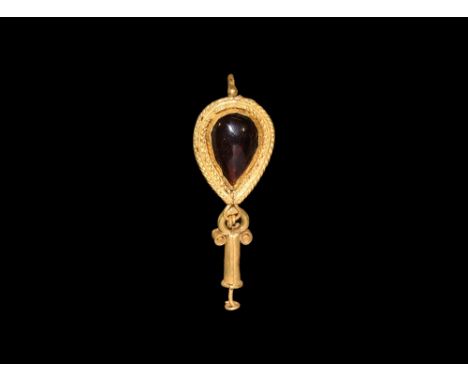 3rd century AD. A gold earring comprising a piriform plaque with filigree border and central cabochon garnet, thick twisted l
