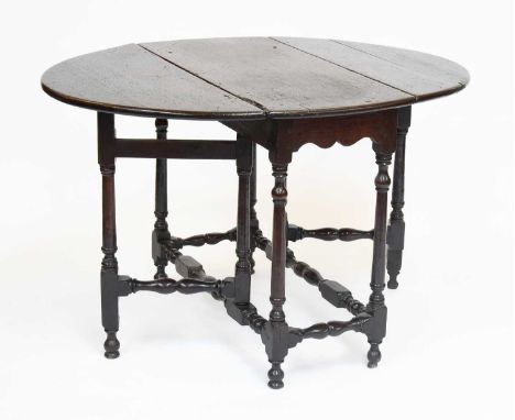 An 18th Century Oak Gate Leg Table, on turned and block supports, 117cm by 90cm by 72cm