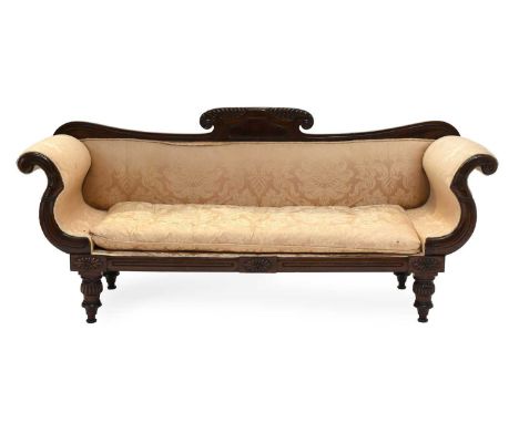 A Regency Carved Mahogany Scroll-End Sofa, early 19th century, recovered in light pink and cream floral damask, the gadrooned