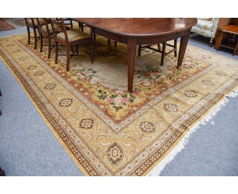 A Gol Farang Carpet, the light camel field with central floral medallion enclosed by mustard borders of acanthus vines, 430cm