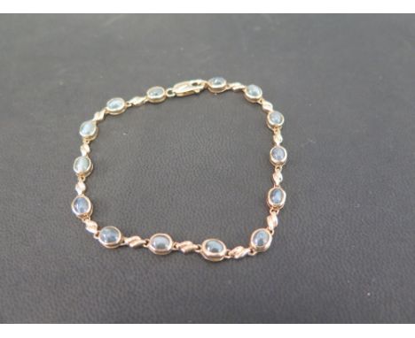 A gem-set panel bracelet - With alternating chatoyant gems and fancy-links - Stamped 375 - Length 20cms - Weight approx 7.8gm