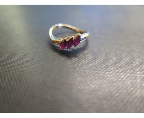 An 18ct gold ruby and diamond dress ring - To the asymmetric shoulders and plain band - Hallmarked London - Ring size N - Wei