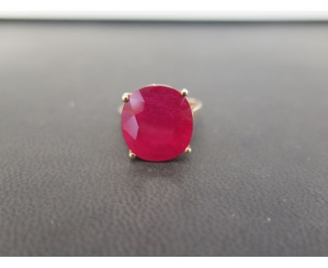 A 9ct gold ruby single-stone ring - The oval ruby to the plain band - Hallmarked Birmingham - Ring size O - Weight approx 5.3