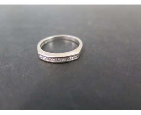 An 18ct gold diamond band ring - The square-shape diamond line, within a channel setting to the plain band - Hallmarked Birmi