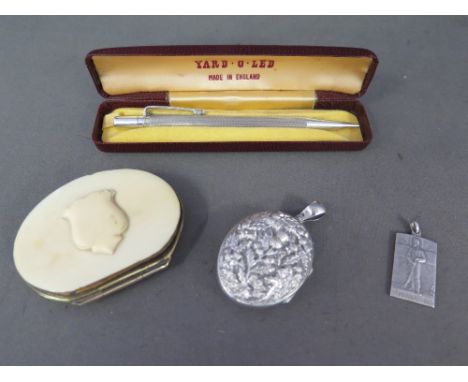 A silver Yard o Lead pencil, an early 20th century French ivory purse, a German silver 1914 pendant and a Sterling silver loc