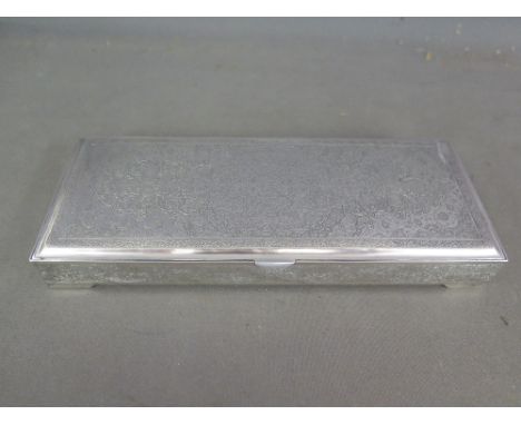 A good quality Middle Eastern/Persian rectangular silver desk cigarette case, marked 84 - 20 cm x 8.5 cm - Total weight appro