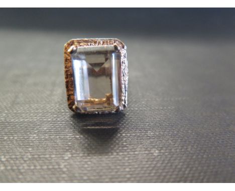 A 1970s 9ct gold smokey quartz single-stone ring - The rectangular smokey quartz to the textured surround and band - Hallmark