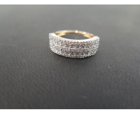 A 9ct gold diamond band ring - The five rows of single and brilliant-cut diamonds to the plain tapered band - Estimated total