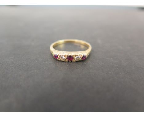 A ruby and diamond boat-shape ring - Stamped 18ct - Ring size Q 1/2 - Weight approx  3.1gms
Condition Report: Good to fair - 