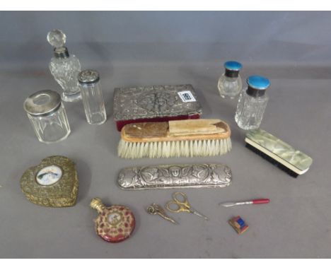 A collection of silver mounted dressing table items, also a gilded metal mounted cranberry scent bottle and gilt metal heart 