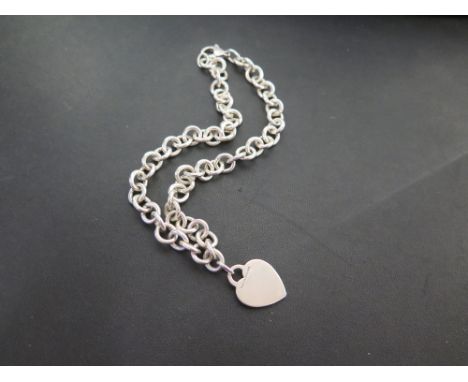 TIFFANY & CO a silver necklace with heart-shape tag - Hallmarked London - Length 41cms - Weight approx 2.2ozt - With associat