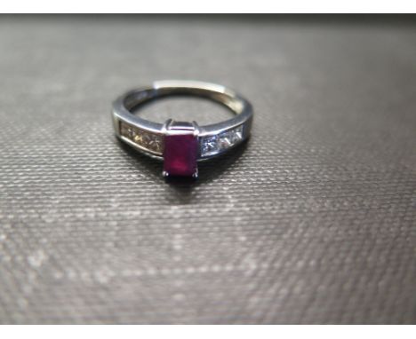 A 9ct gold ruby and diamond dress ring - The rectangular ruby to the square-shape diamond shoulders and plain band - Hallmark