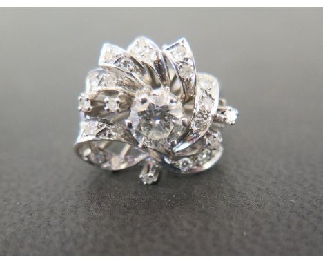 A diamond cluster dress ring - The central brilliant-cut diamond within a vari-cut diamond scroll and spray surround - Princi