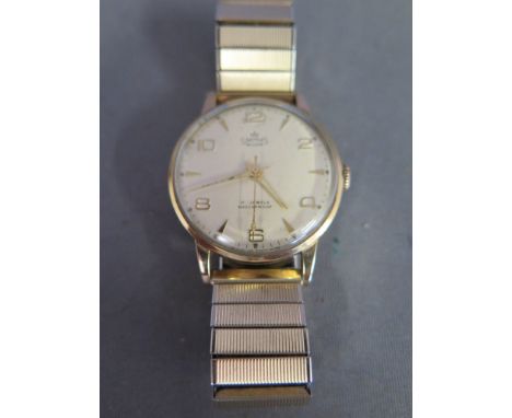 A Gents 9 ct Gold Smiths 17 jewel wristwatch on a gold plated expanding bracelet, Arabic numeral and baton markers, central s