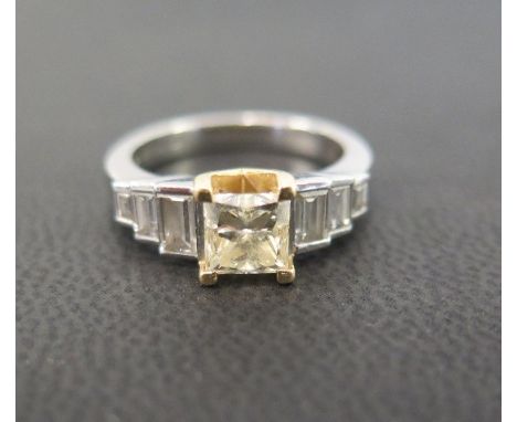 A platinum yellow diamond and diamond dress ring - The square-shape yellow diamond to the graduated baguette-cut diamond shou