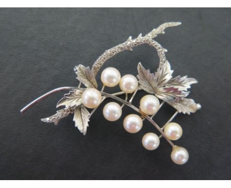 A cultured pearl foliate spray brooch - With nine cultured pearls to the textured leaves - Stamped 14K - Width 7.5cms - Total