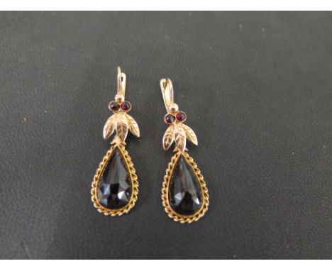 A pair of Bohemian garnet ear pendants - With leaf detail - Test as 9ct gold - Length 4.7cms - Weight approx 7.9gms
Condition