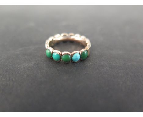 A turquoise band ring - Believed to be Georgian gold - The five circular cabochons to the scalloped band - Ring size K - Weig