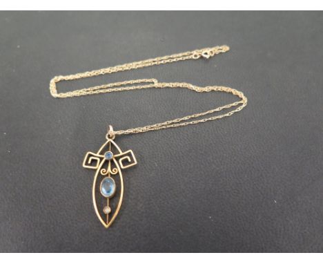 A blue-gem and seed pearl openwork pendant - Suspended from a fancy-link chain - Chain stamped 375 - Length of pendant 3.8cms