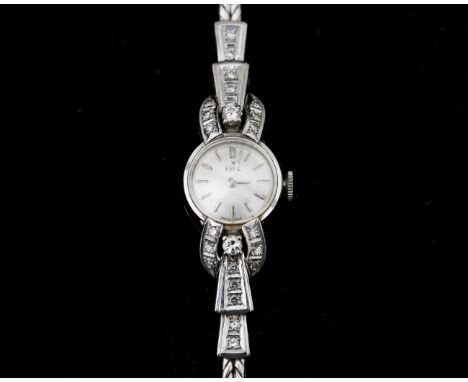 An 18 karat white gold wristwatch by Ebel, case: 15 mm. platinum-coloured dial, silver-coloured dashed indexes and hands, mec