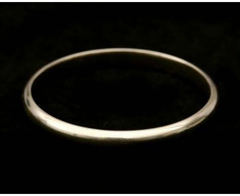 A 14 karat gold bangle with thonge clasp and hinge. Weight: 19.7 g. Diameter: ca. 54 x 60 mm. 