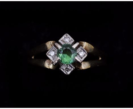 A 14 karat gold ring set in the middle with a round faceted cut light green tourmaline with an entourage of pavé devoid of fo