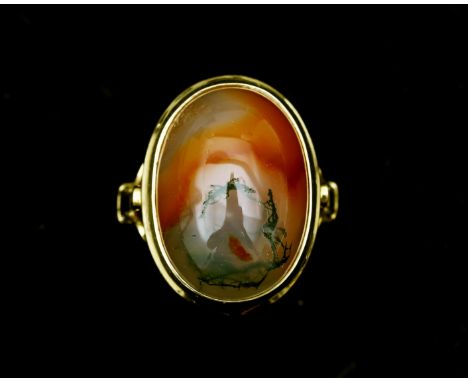 A 14 karat gold ring with cabochon cut moss agate. The agate lies high on the ring and is set in a smooth conversion. 5.8 g. 