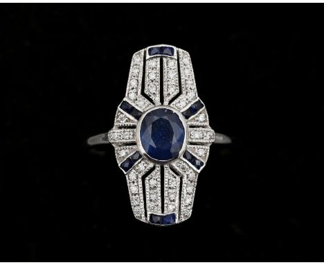 A 14 karat white gold ring, after ArtDeco model, centrally set with an oval cut sapphire (treated) approx. 0.55ct. surrounded