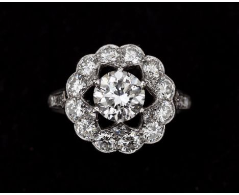 A 14 karat white gold with platinum rosette ring, centrally set with a brilliant cut diamond, 1.22ct. Color E, Purity VS1. in